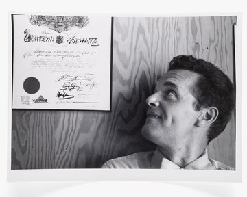 Photograph of Charles Eames with Steinberg Diploma