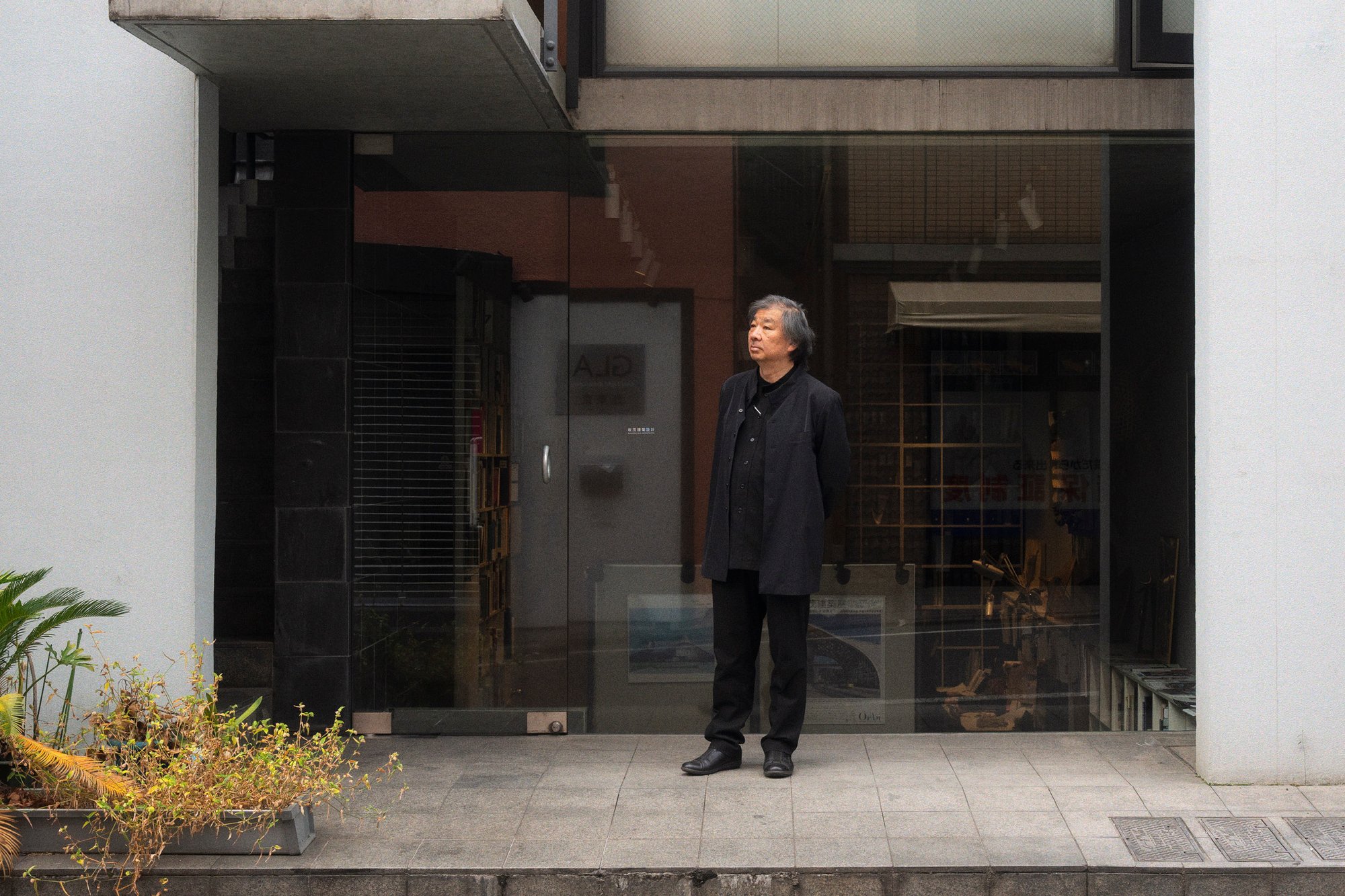 Shigeru Ban photographed outside the Tokyo office of Shigeru Ban Architects.